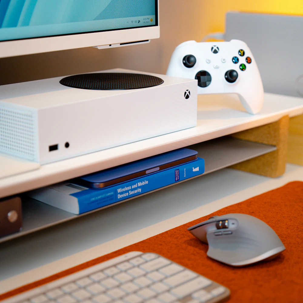 Compact white Xbox Series S console with matching wireless controller on a desk