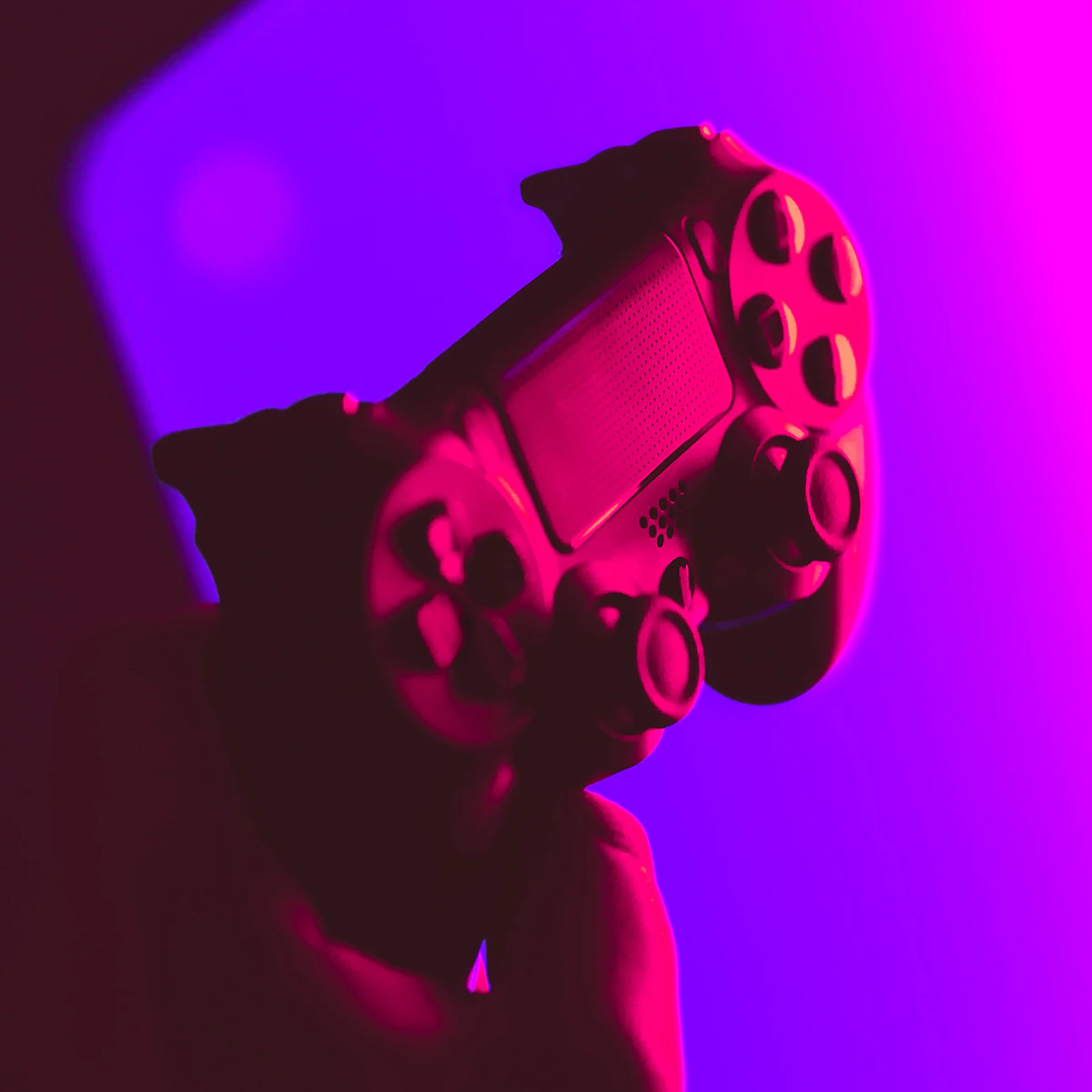 Game controller lit in pink and purple neon light