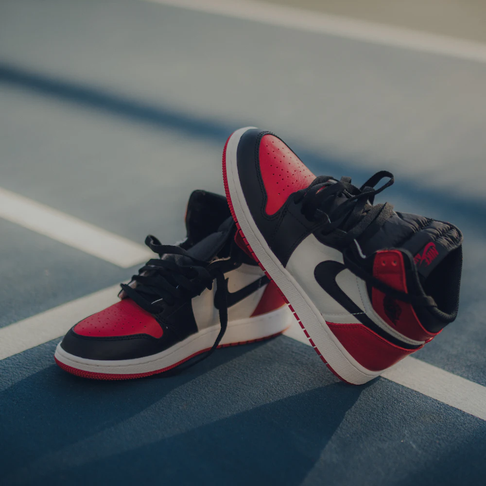 Air Jordan 1 Retro High OG Bred Toe sneakers with red toe box, black Swoosh, and white body